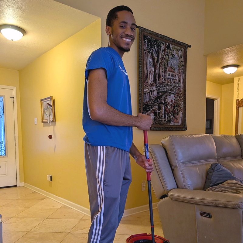Linked Lives helper cleaning a living room