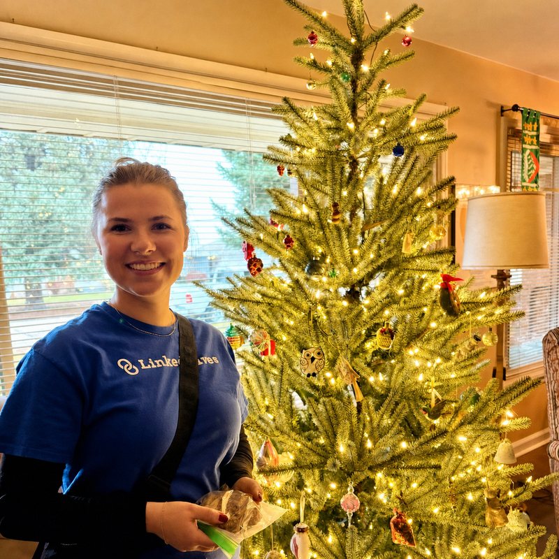 Linked Lives helper decorating a Christmas tree
