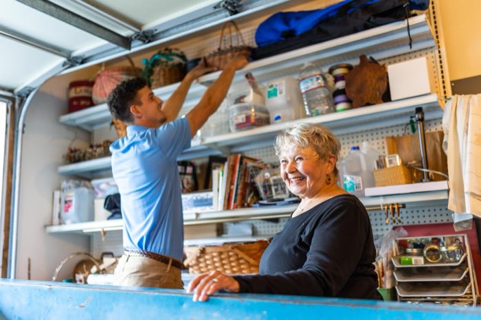 Linked Lives helper organizing household storage items with a senior